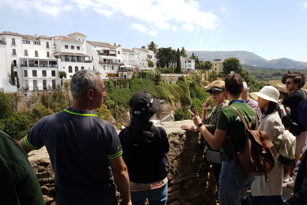 Travelers at a viewpoint over the Tajo gorge in Ronda