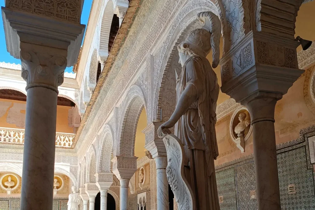 Classical statue beside the arcade of the Casa de Pilatos in Seville