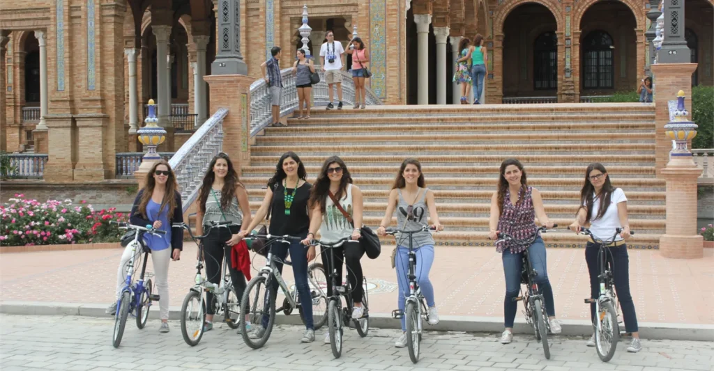 A bike tour group with their bicycles in front of the Plaza de Espana in Seville