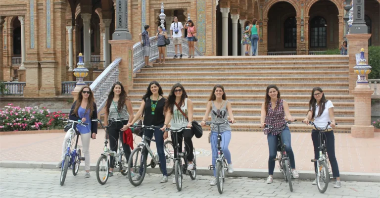 A bike tour group with their bicycles in front of the Plaza de Espana in Seville