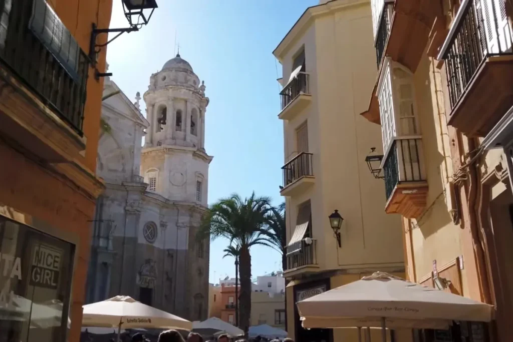 Street in the old town of Cadiz with the cathedral tower behind