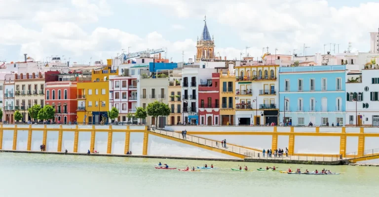 The coloured houses of Calle Betis seen across the Guadalquivir in Triana, Seville