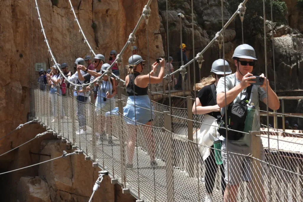 Visitors crossing the suspension bridge on the Caminito del Rey