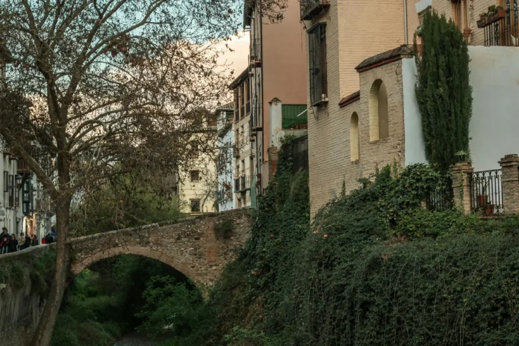 Stone bridge over the Darro river on the Carrera del Darro in Granada