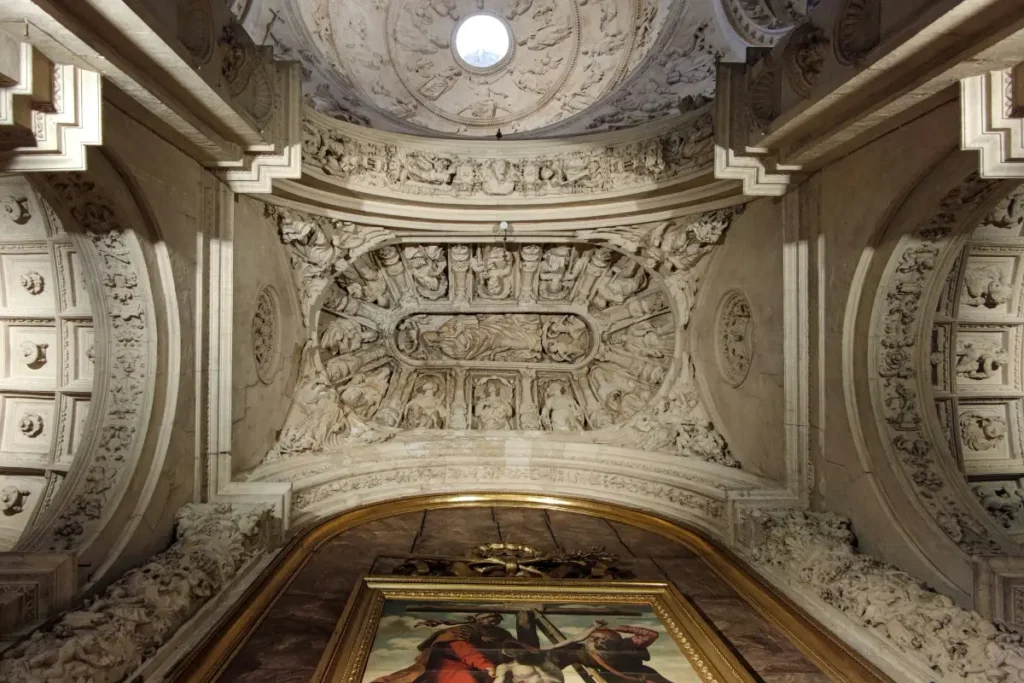 Carved plasterwork ceiling above a painting in Seville Cathedral