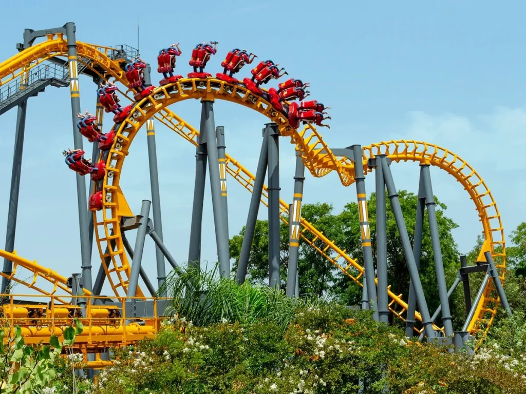 A chair swing ride turning above the trees at Isla Magica in Seville