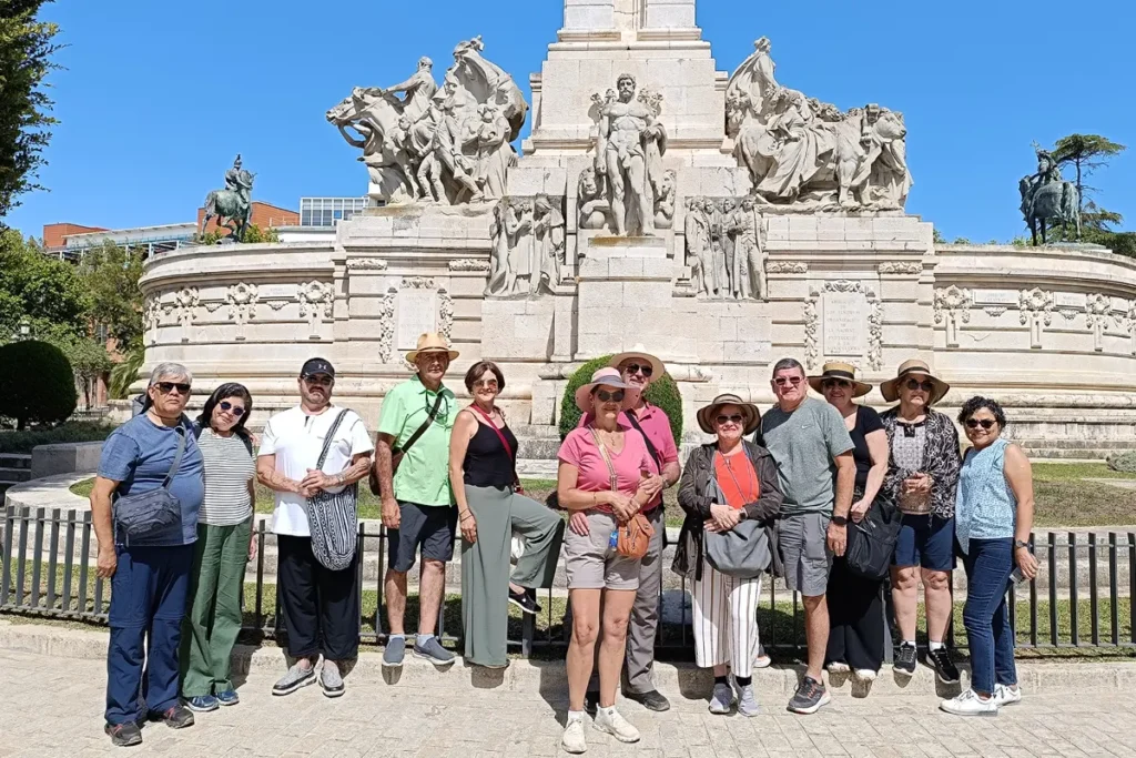 A group beside the monument to the Constitution of 1812 in Cadiz
