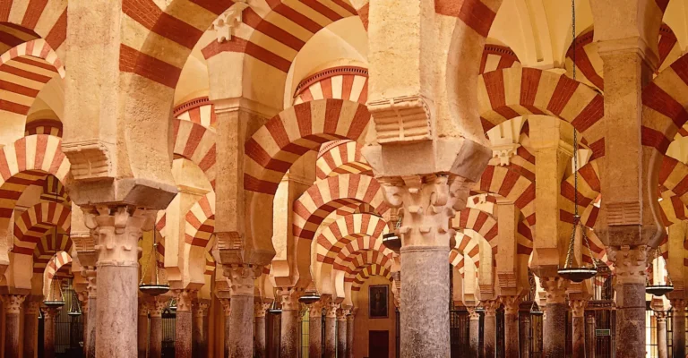 Rows of red and white double arches inside the Mosque-Cathedral of Cordoba