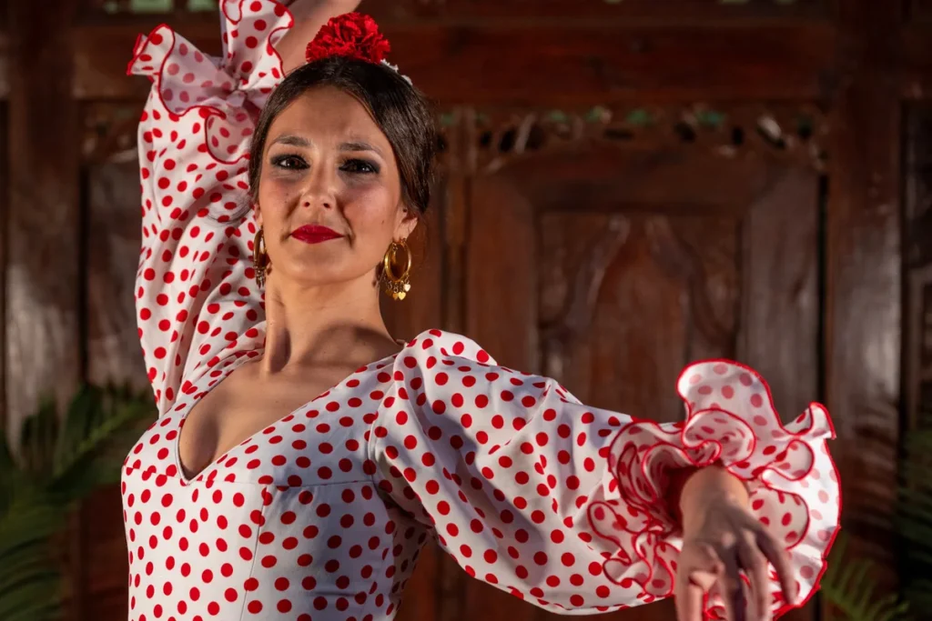 A flamenco dancer in a red and white polka-dot dress mid-turn