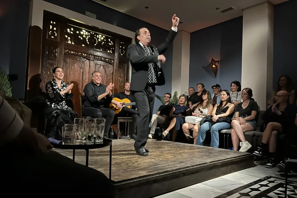 A flamenco dancer on stage in front of the audience at a tablao in Triana, Seville
