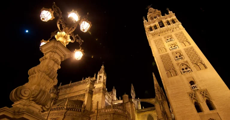 The Giralda and a lit street lamp at night in Seville