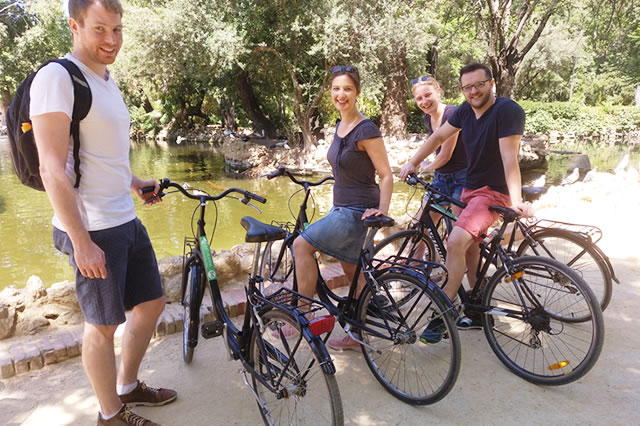 People with hire bikes beside the Guadalquivir in Seville