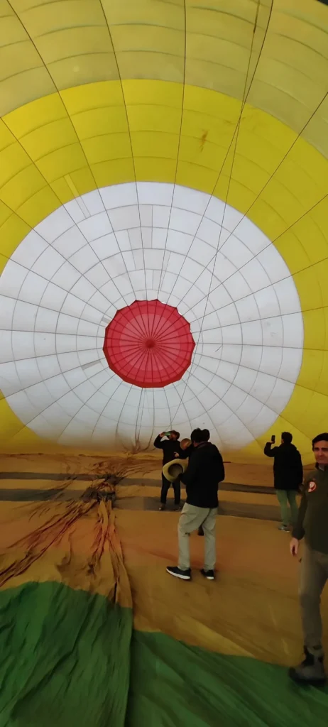 Looking up into the envelope of a hot air balloon as it inflates