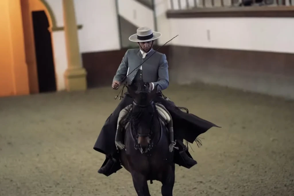 Rider in traditional Andalusian costume on horseback at the riding school