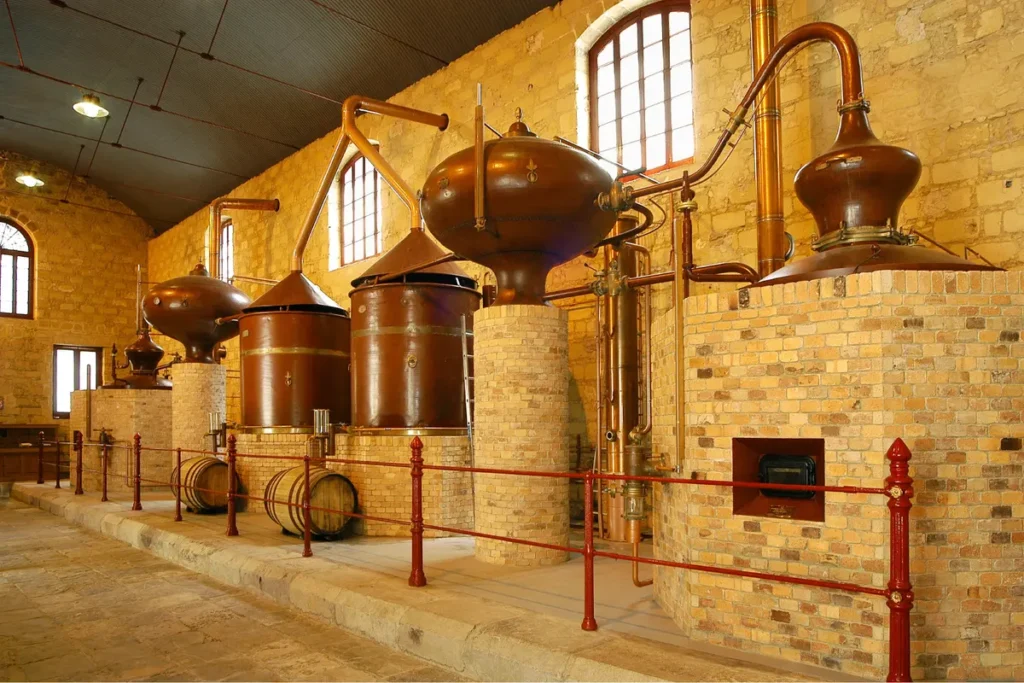 Copper stills and oak barrels inside a sherry winery in Jerez