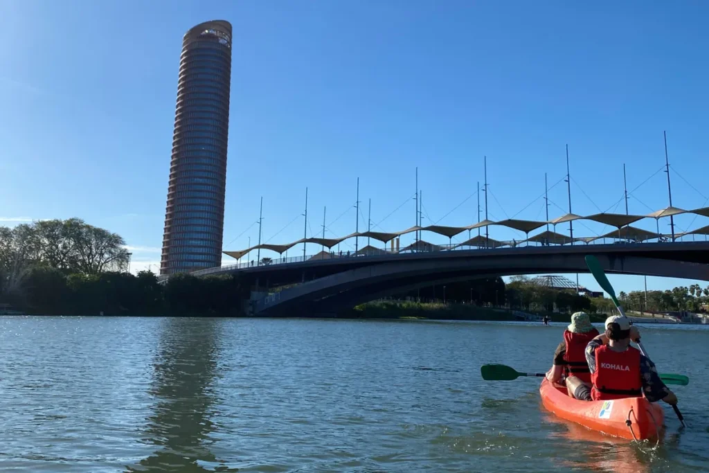 A kayak on the Guadalquivir below the Barqueta bridge and the Torre Sevilla
