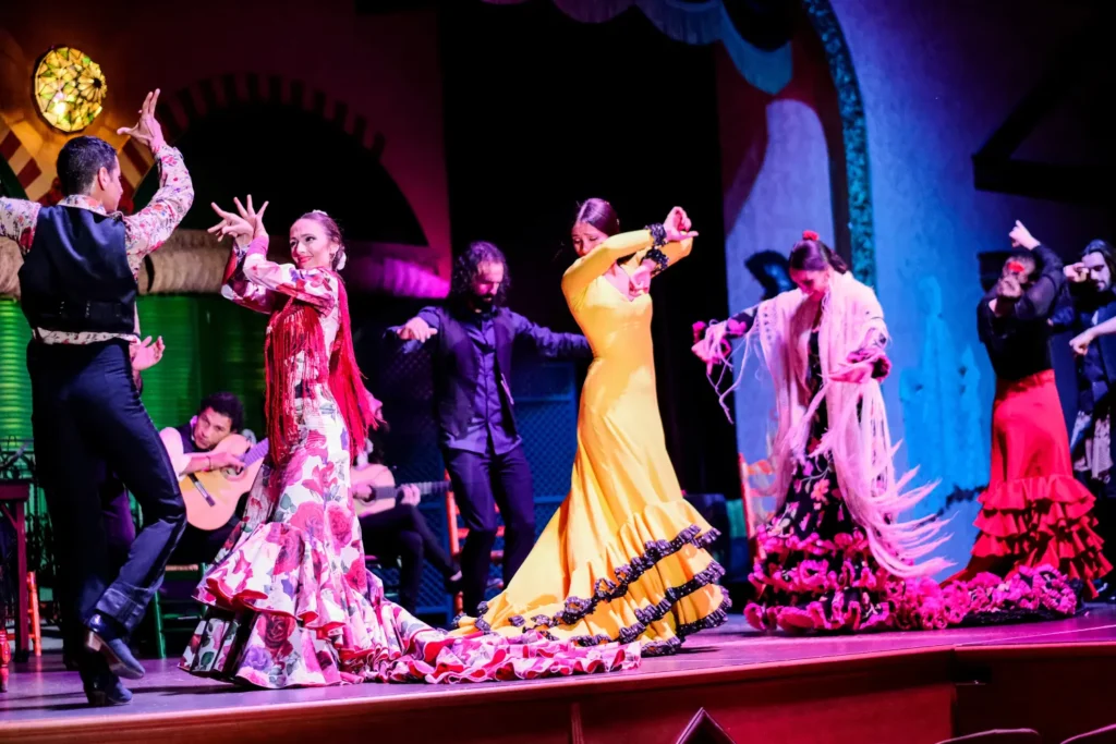 A large flamenco company on stage in a theatre in Seville