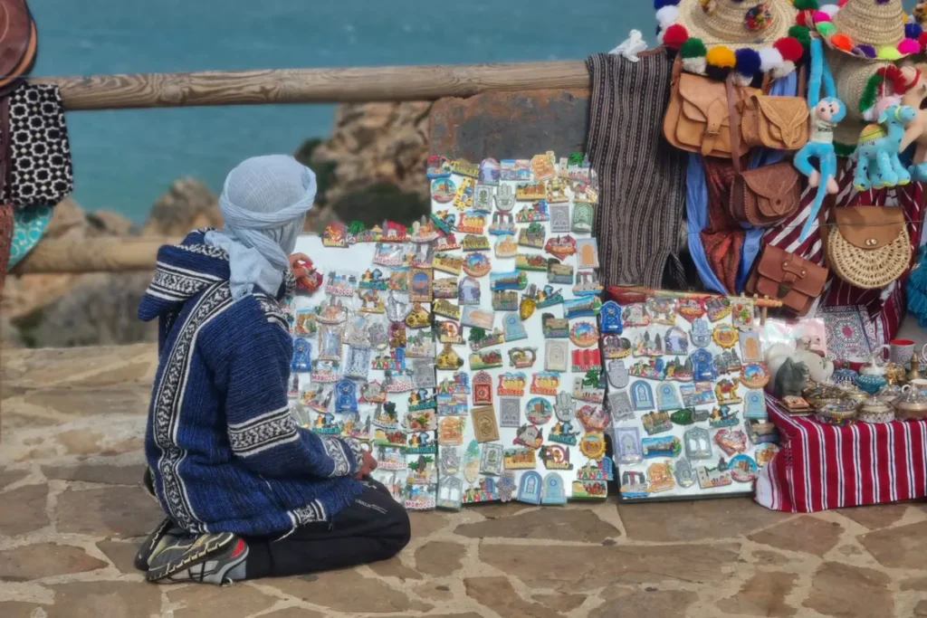 Souvenir stall with Moroccan magnets and leather bags above the Atlantic coast