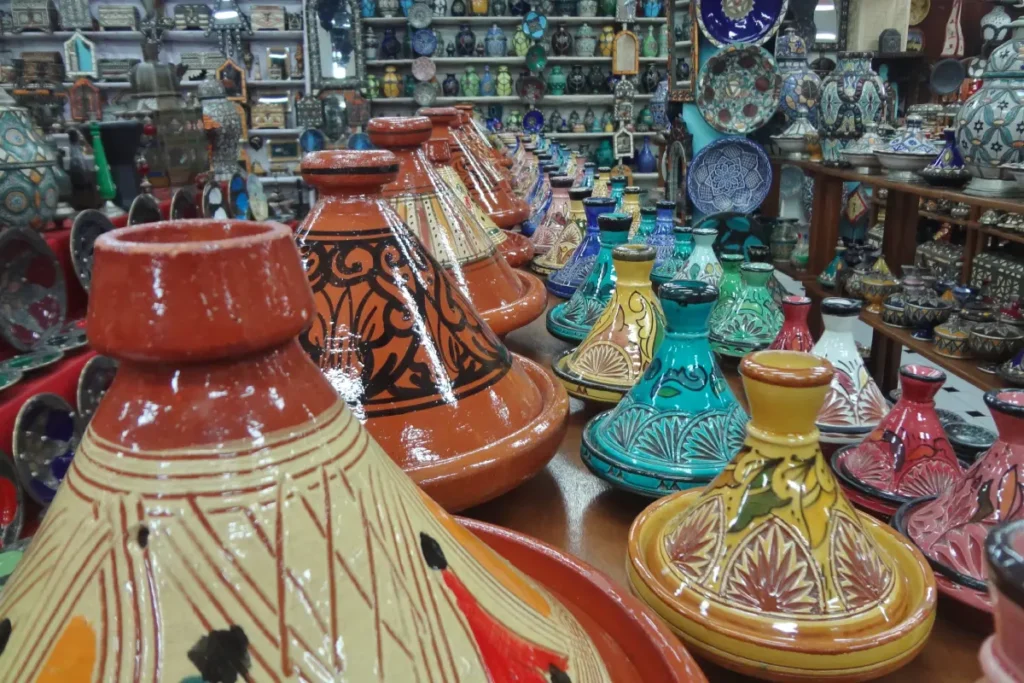 Painted tagines and glazed pottery stacked in a Moroccan shop