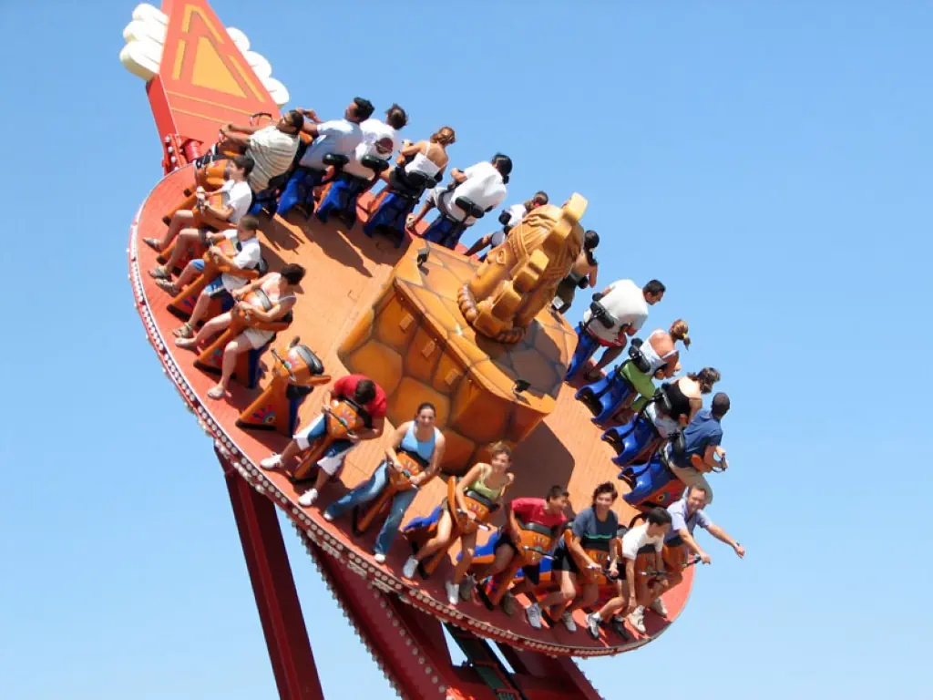A swinging pirate ship ride full of visitors at Isla Magica in Seville