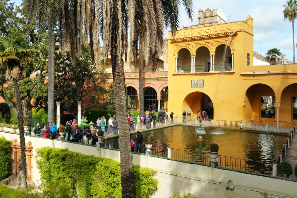Rectangular pond and palm trees in the gardens of the Royal Alcazar of Seville