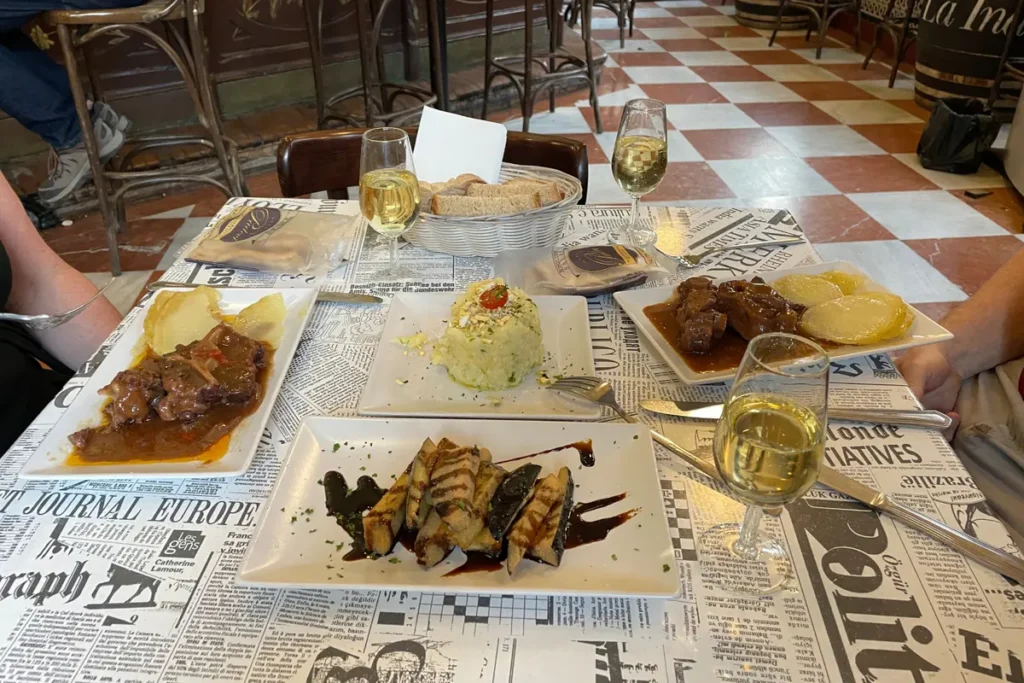 Prawns and a stew served in earthenware dishes at a bar in Seville