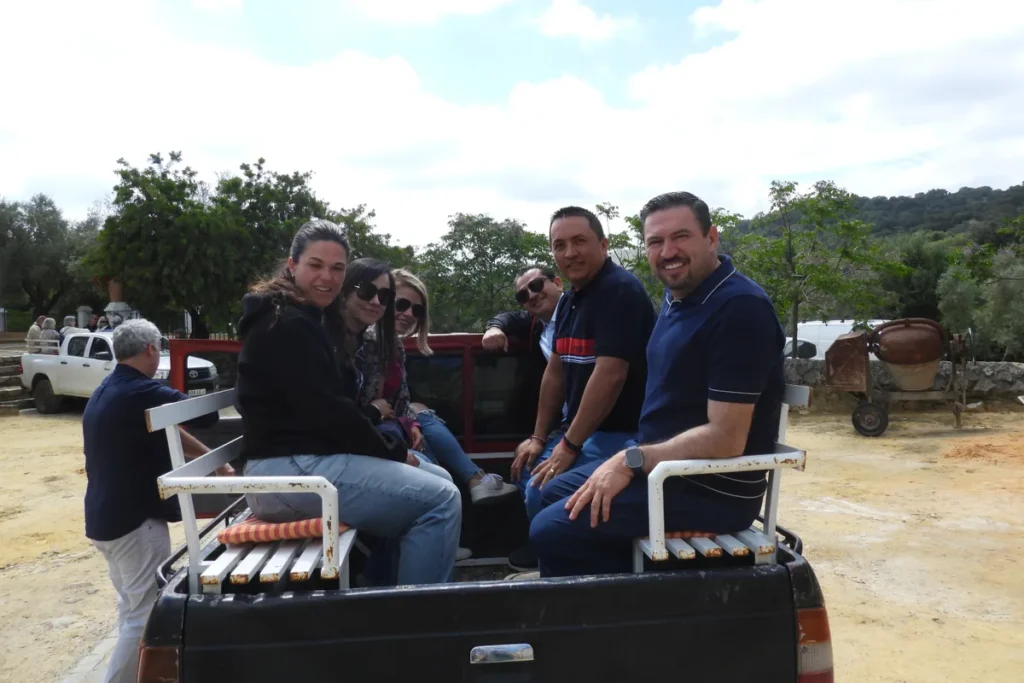 Visitors seated in the open ranch vehicle before touring the pasture