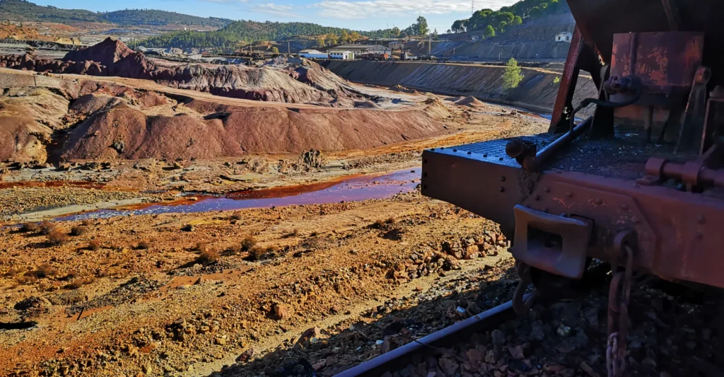 The terraced open-pit workings of the Rio Tinto mines with an old rail wagon