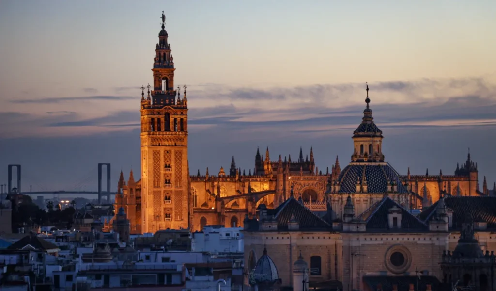 The Cathedral and the Giralda rising over the rooftops of Seville at sunset