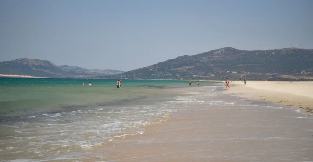 Long sandy beach at Tarifa with the hills of the Costa de la Luz behind