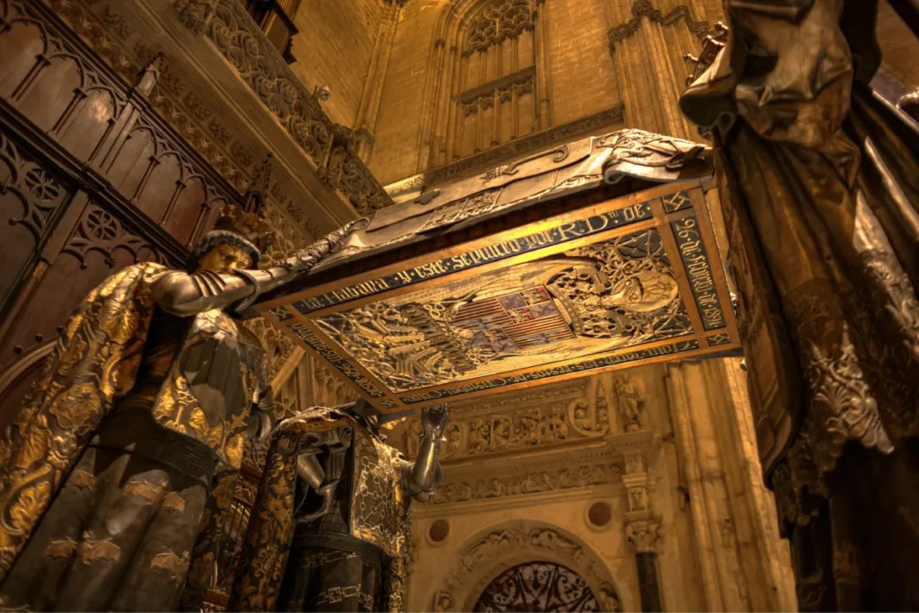 The tomb of Christopher Columbus carried by four heralds in Seville Cathedral