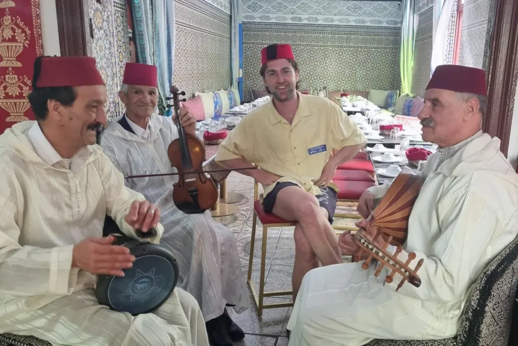 Musicians playing traditional instruments in a tiled Moroccan restaurant