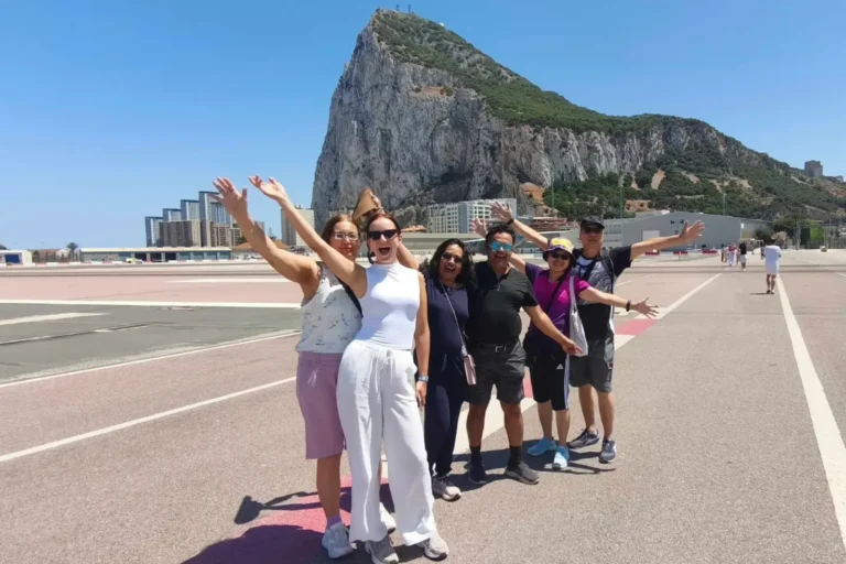 A group of travelers with the Rock of Gibraltar behind them
