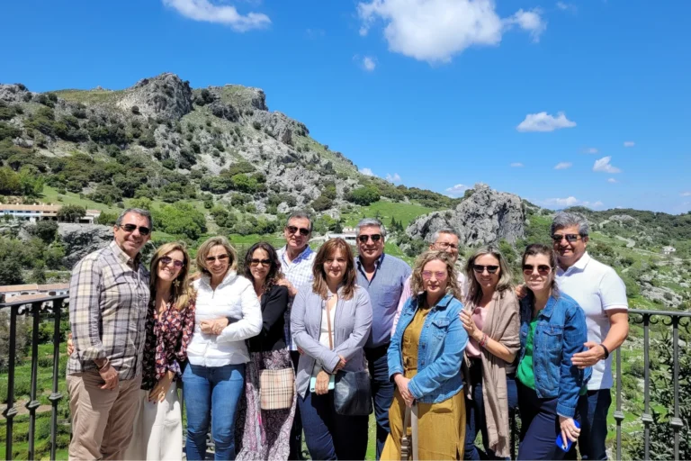 A group of travelers with the Sierra mountains behind them