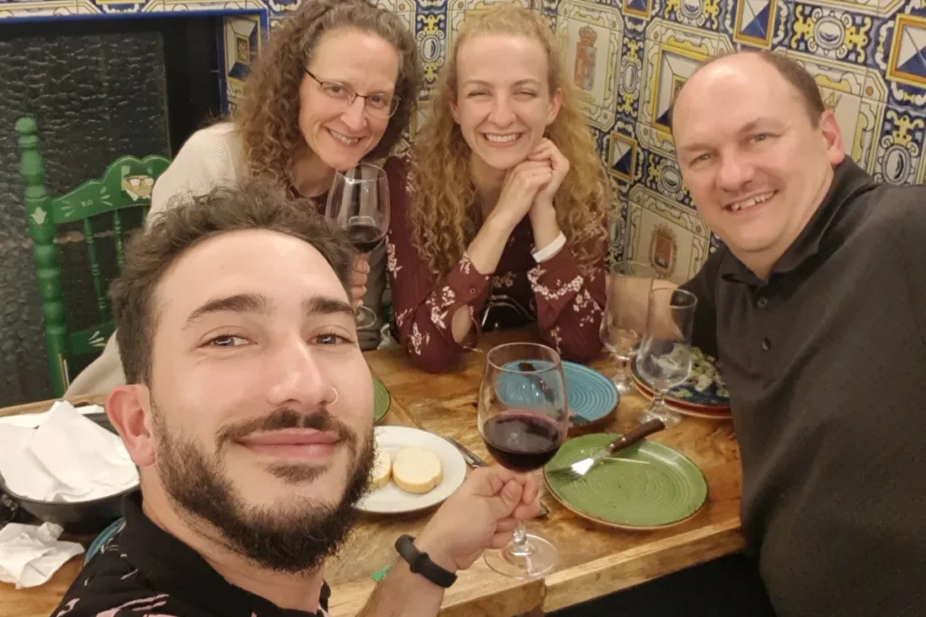 A group enjoying wine and tapas around a table in a bar in Triana