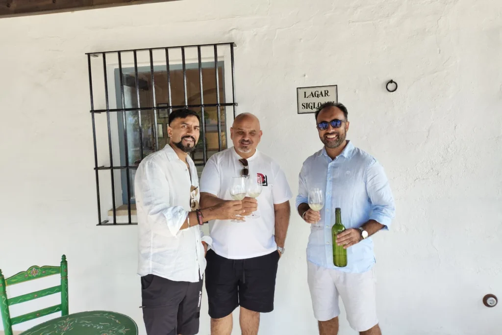 Visitors tasting wine at a table on the terrace of an Andalusian winery