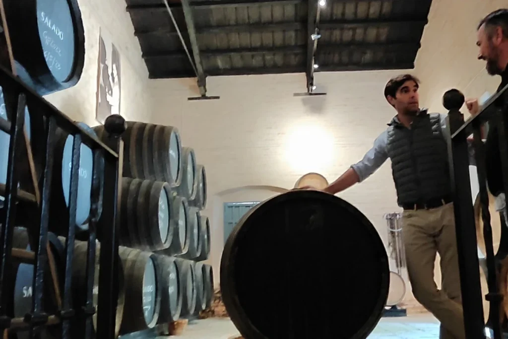 A winemaker explaining how the wine ages in large wooden casks